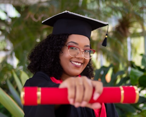 smiling woman wearing academic dress and black academic hat