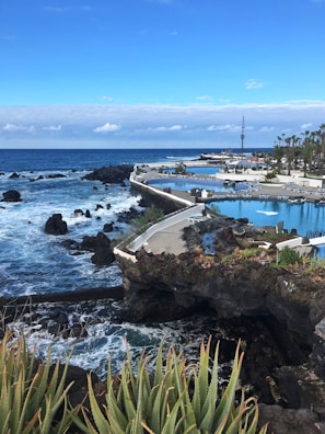 A scenic view of the rugged cliffs and natural pools at Shete Boka National Park.