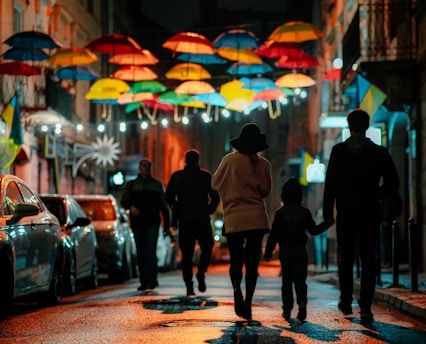 man in white hoodie walking on street during night time