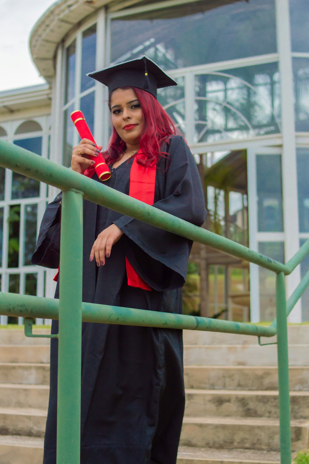 woman in black coat holding red plastic cup