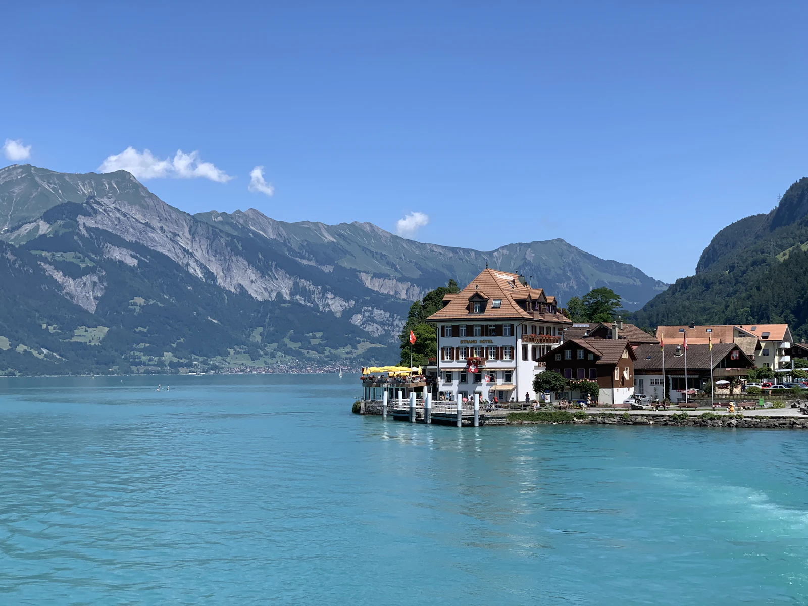 Interlaken houses beside a blue lake and mountains in summer