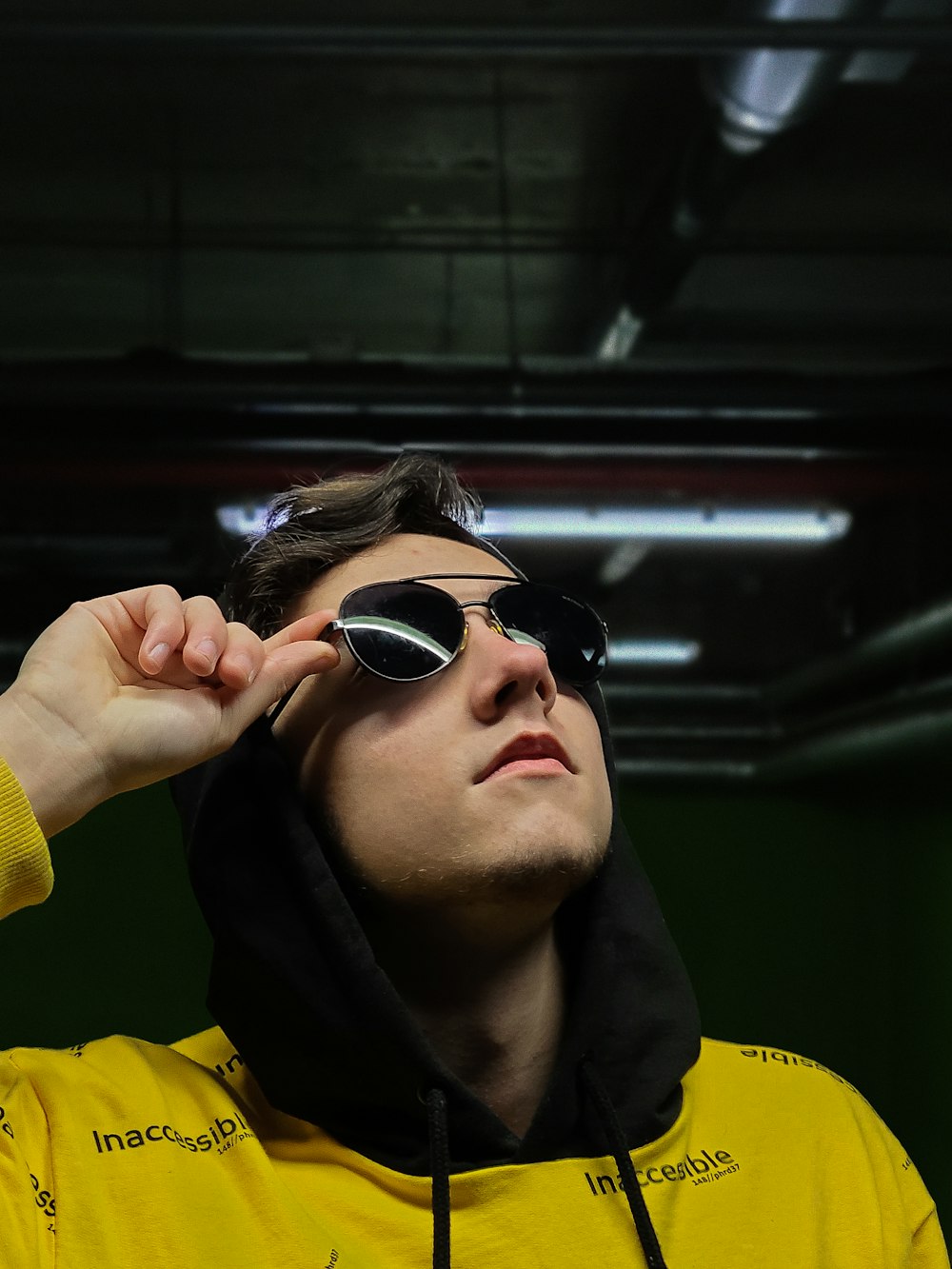 man in yellow jacket wearing black sunglasses