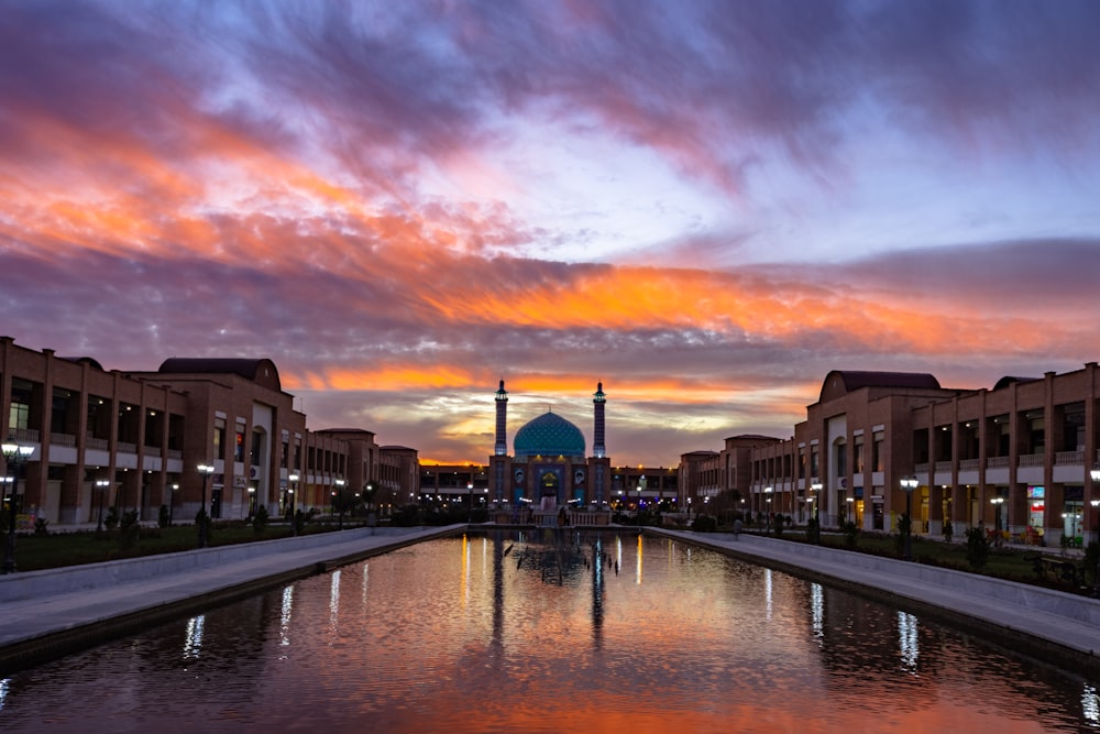 river between buildings during sunset