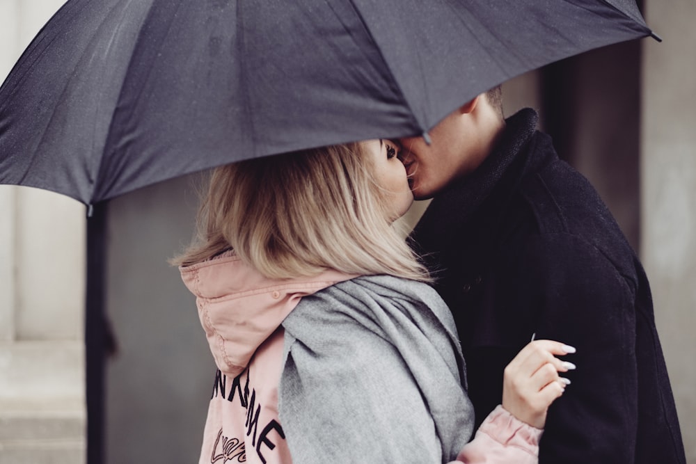 woman in gray hoodie holding umbrella