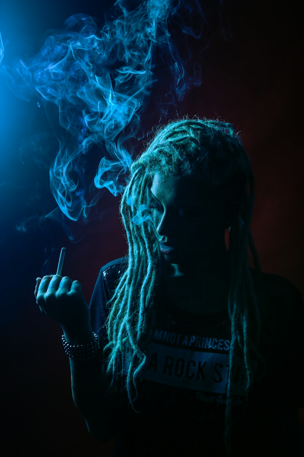 man in black crew neck t-shirt smoking cigarette