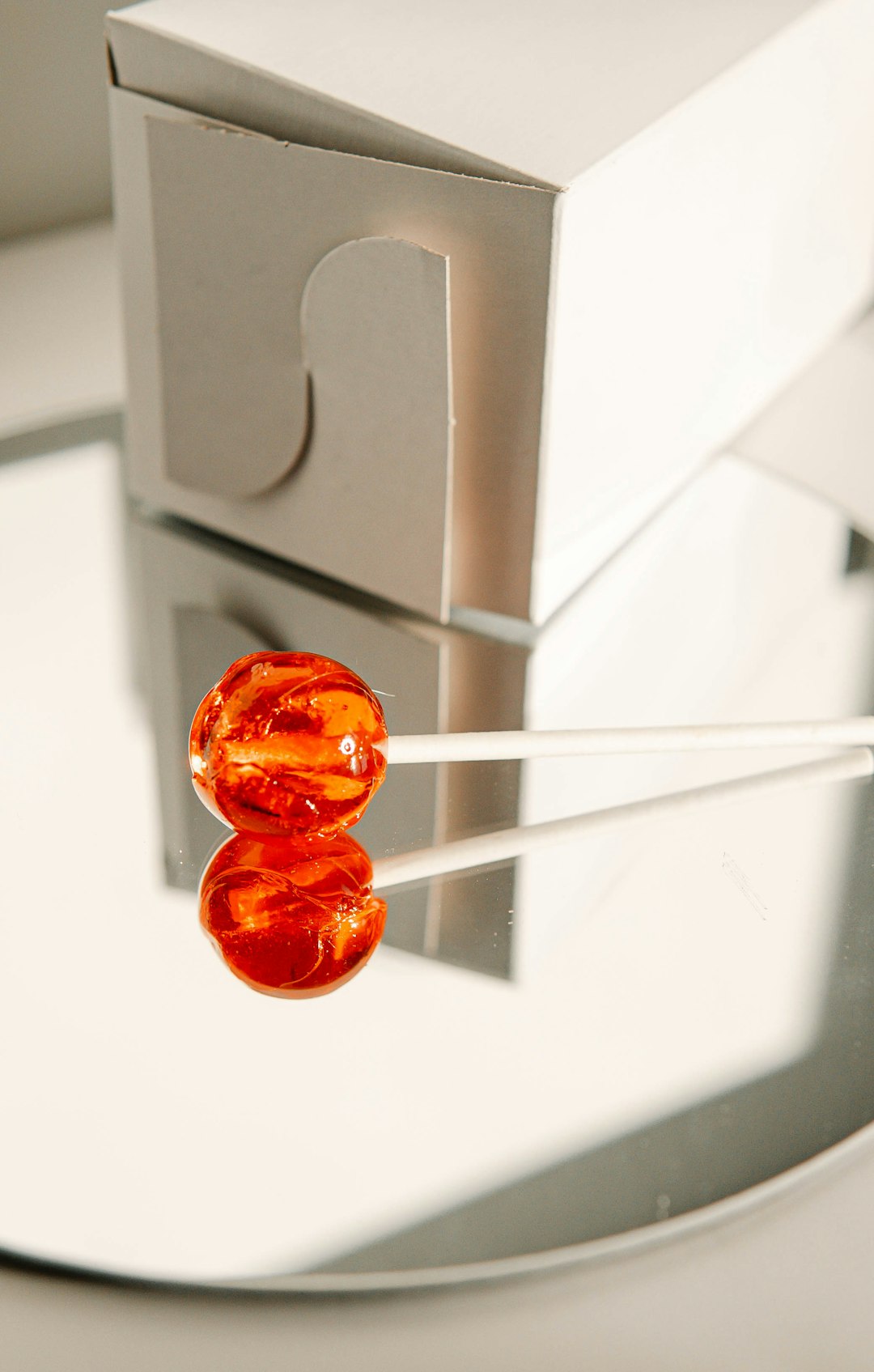 red and orange candy on white surface