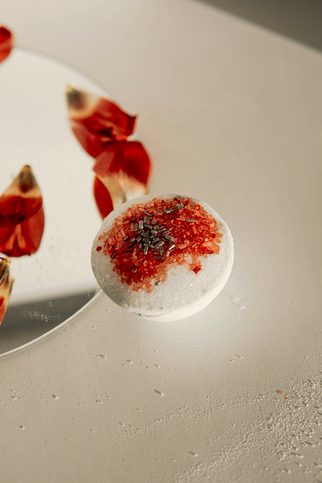 white and red round fruit on white table