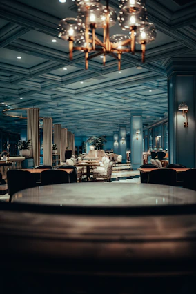 Elegant dining area with warm lighting and beautifully plated gourmet dishes.