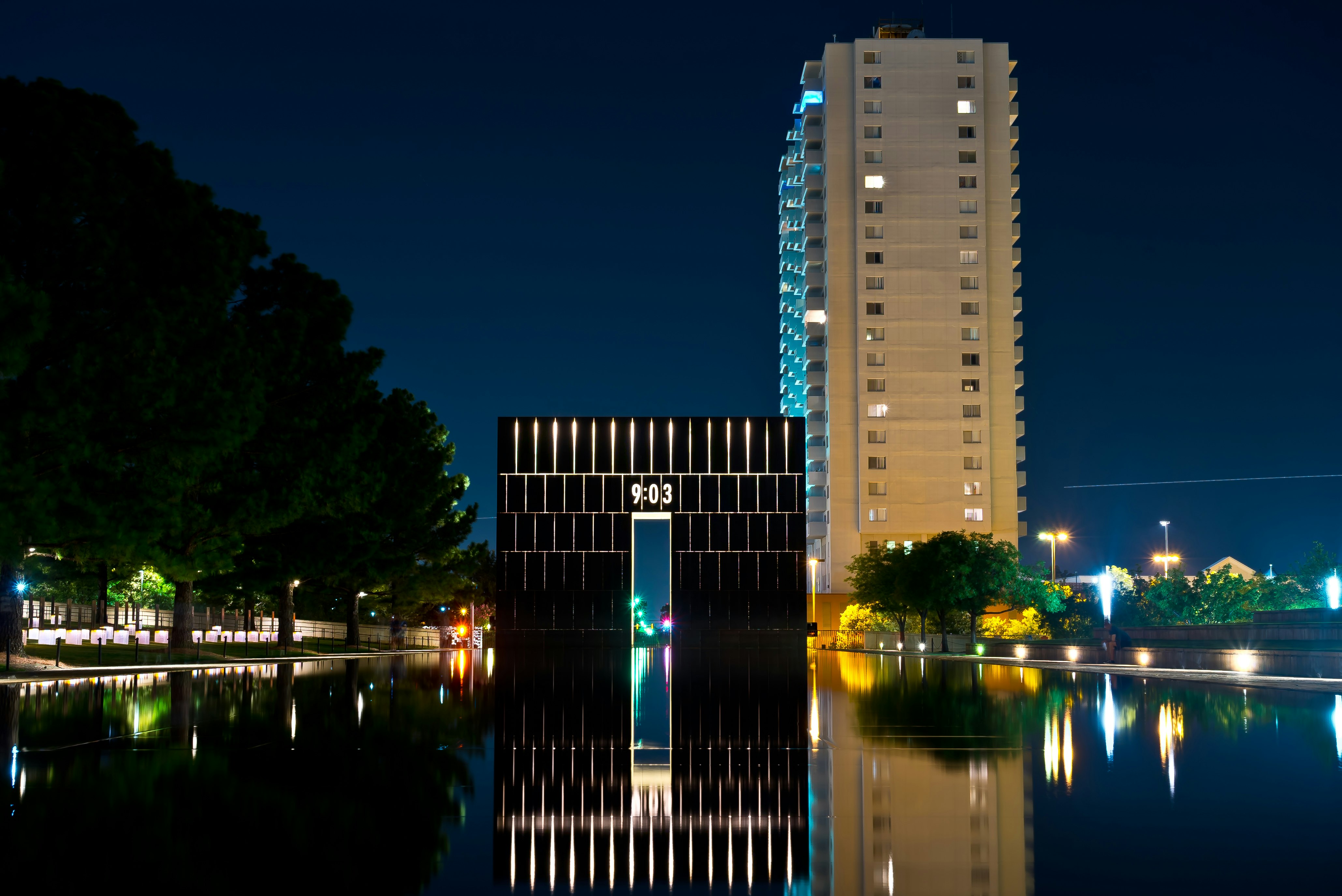 high rise building near body of water during night time