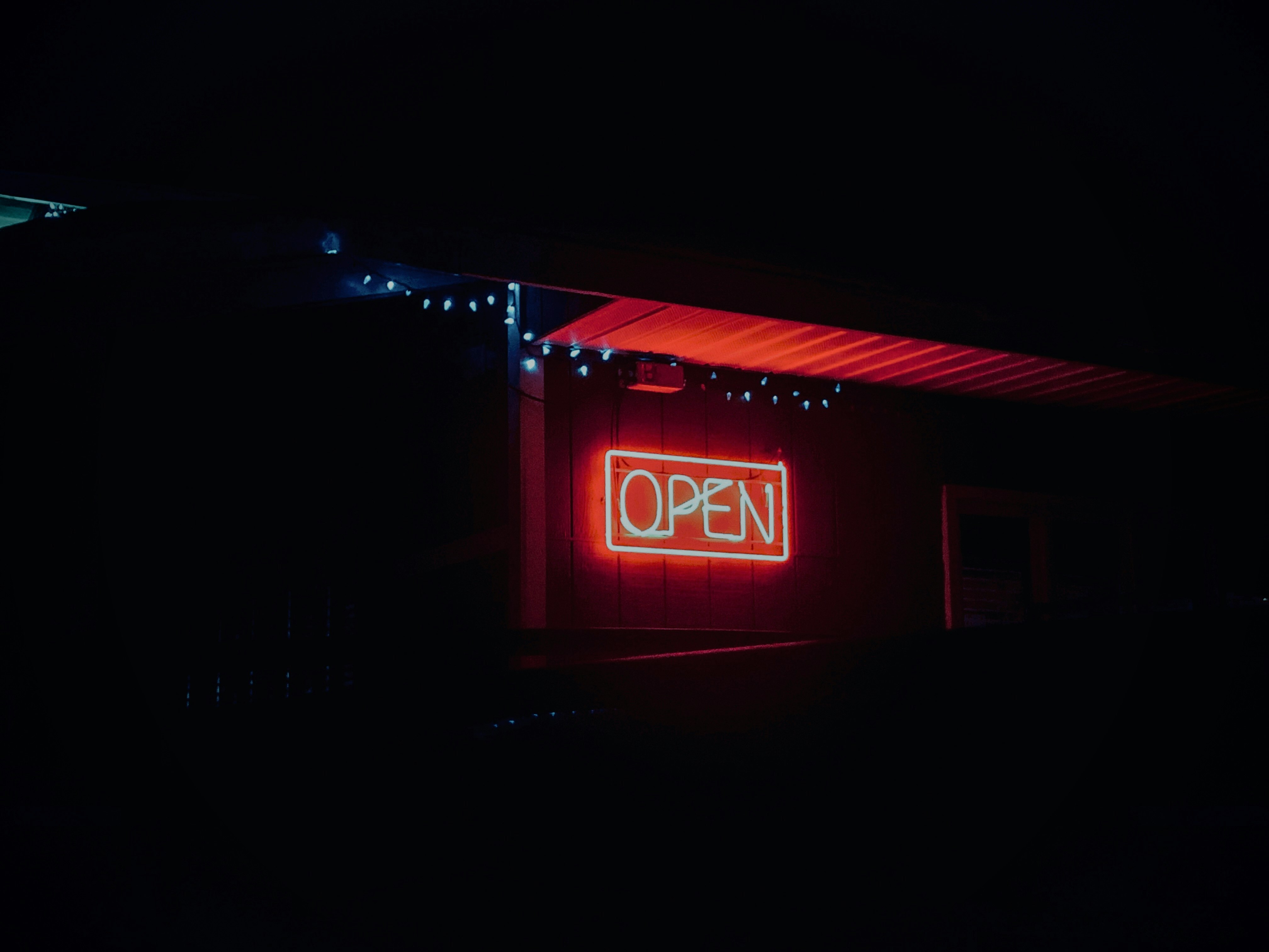 red and black open neon signage