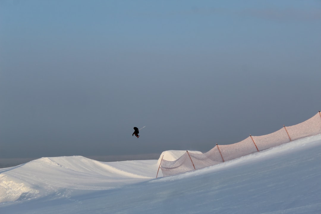 person walking on white sand during daytime