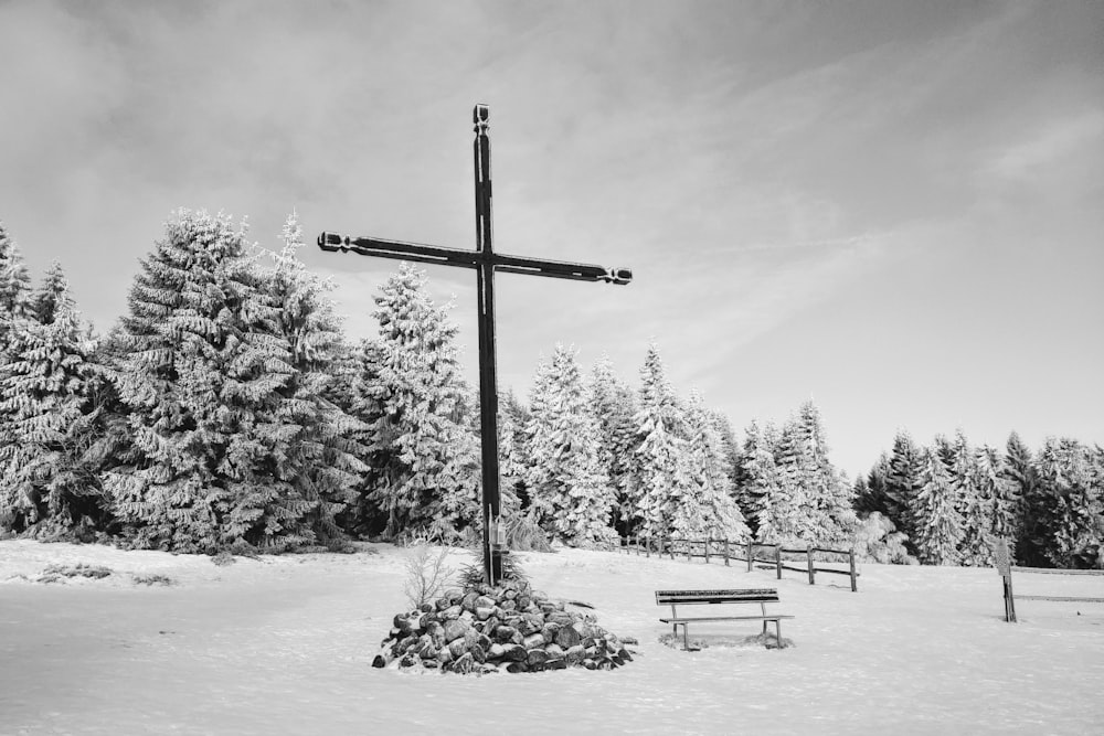 black wooden cross on snow covered ground