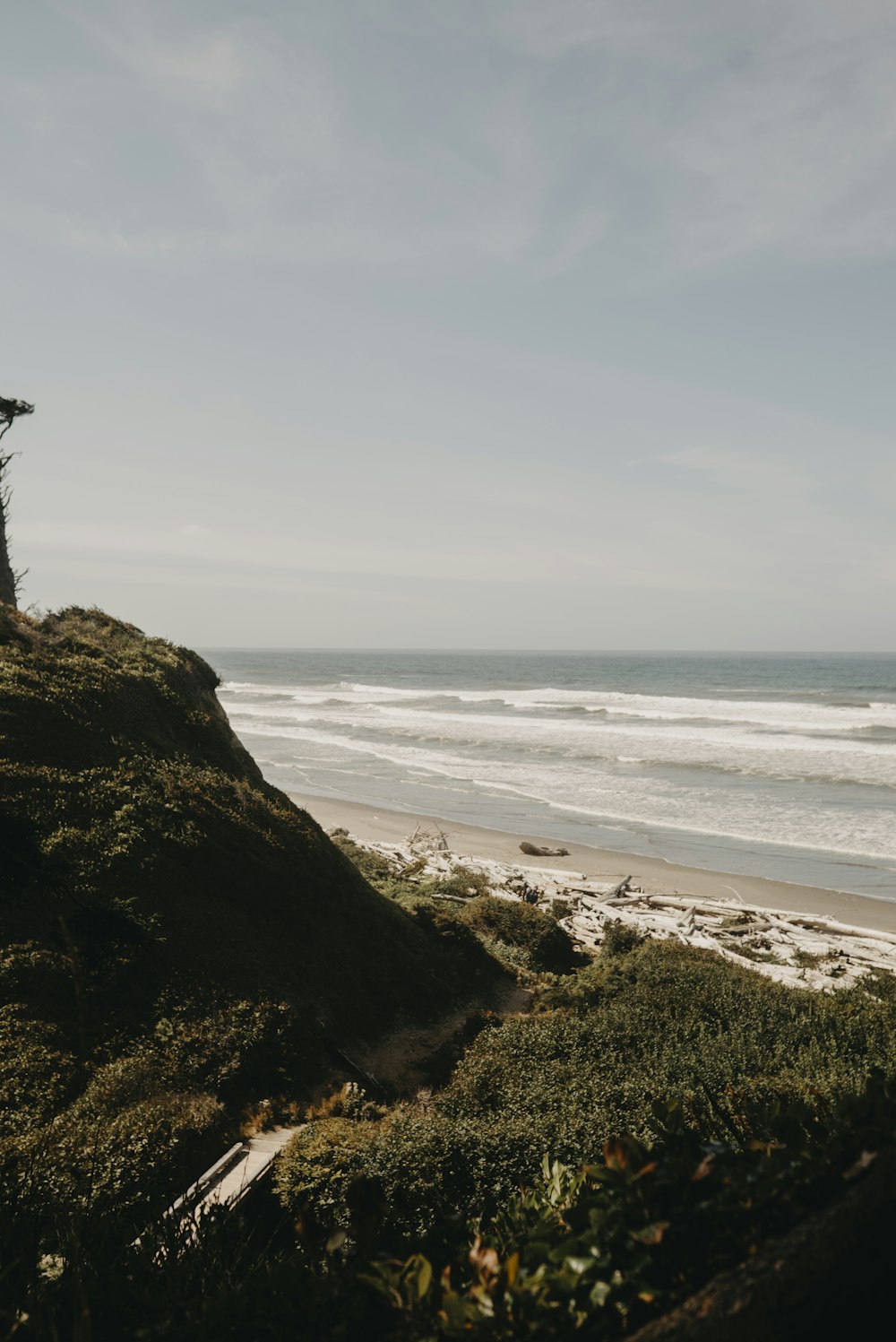 person standing on rock formation near sea during daytime