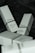 Several white boxes with a minimalist design are scattered on a dark surface. The boxes are branded with 'The Ordinary' and contain skincare products such as Caffeine Solution 5% + EGCG and 100% Organic Cold-Pressed Moroccan Argan Oil. The boxes contain details about each product, including usage instructions and quantities.