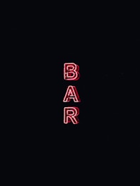 A neon sign displays the word 'BAR' in bold, red capital letters against a dark background.