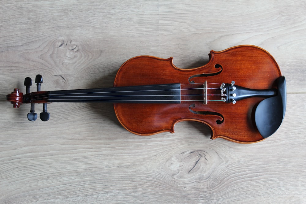 brown violin on white textile