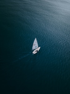 white boat on blue sea during daytime