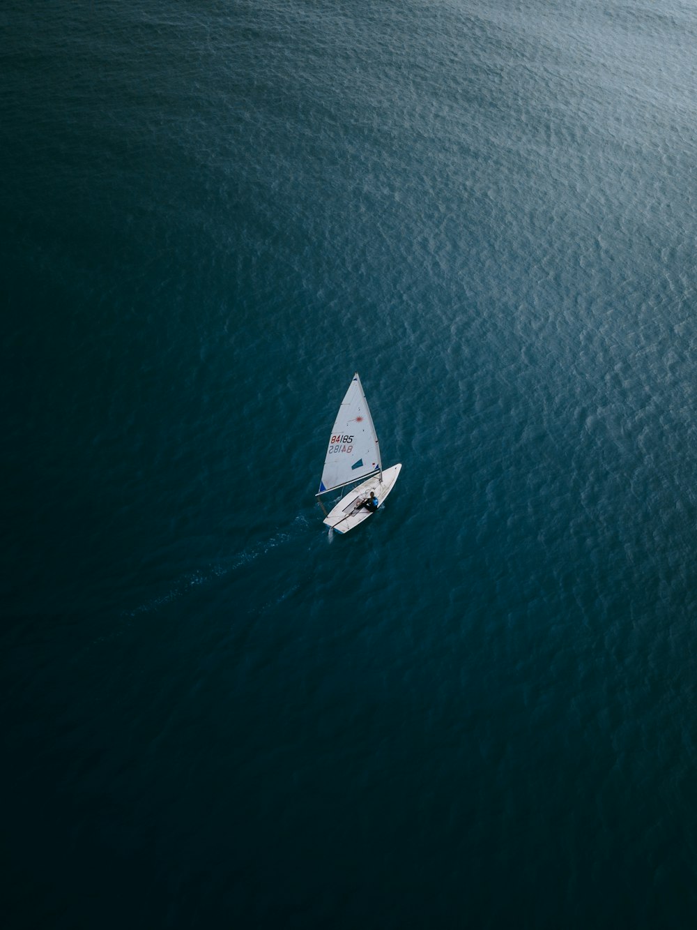 white boat on blue sea during daytime