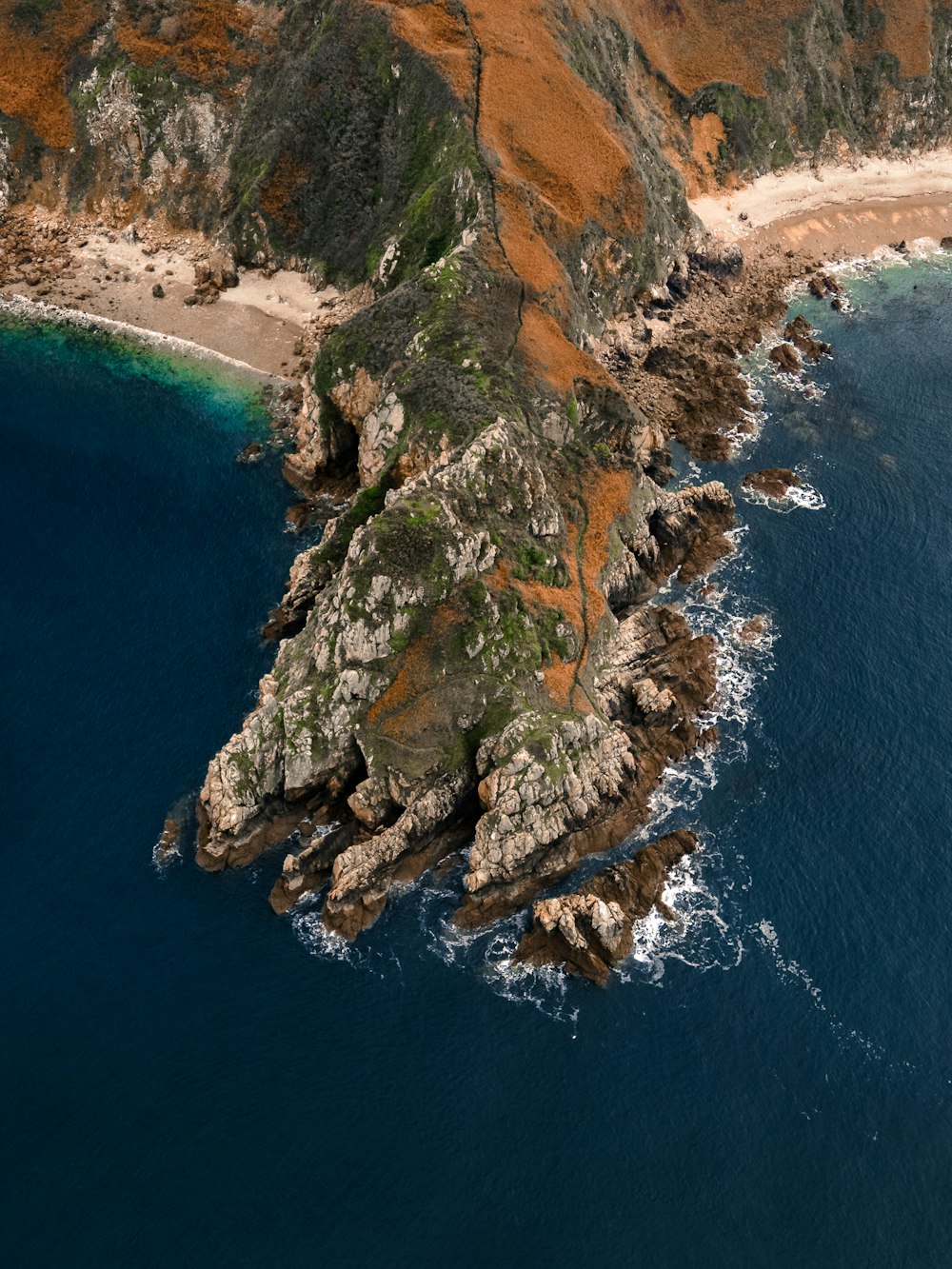 brown and gray rock formation beside blue sea during daytime