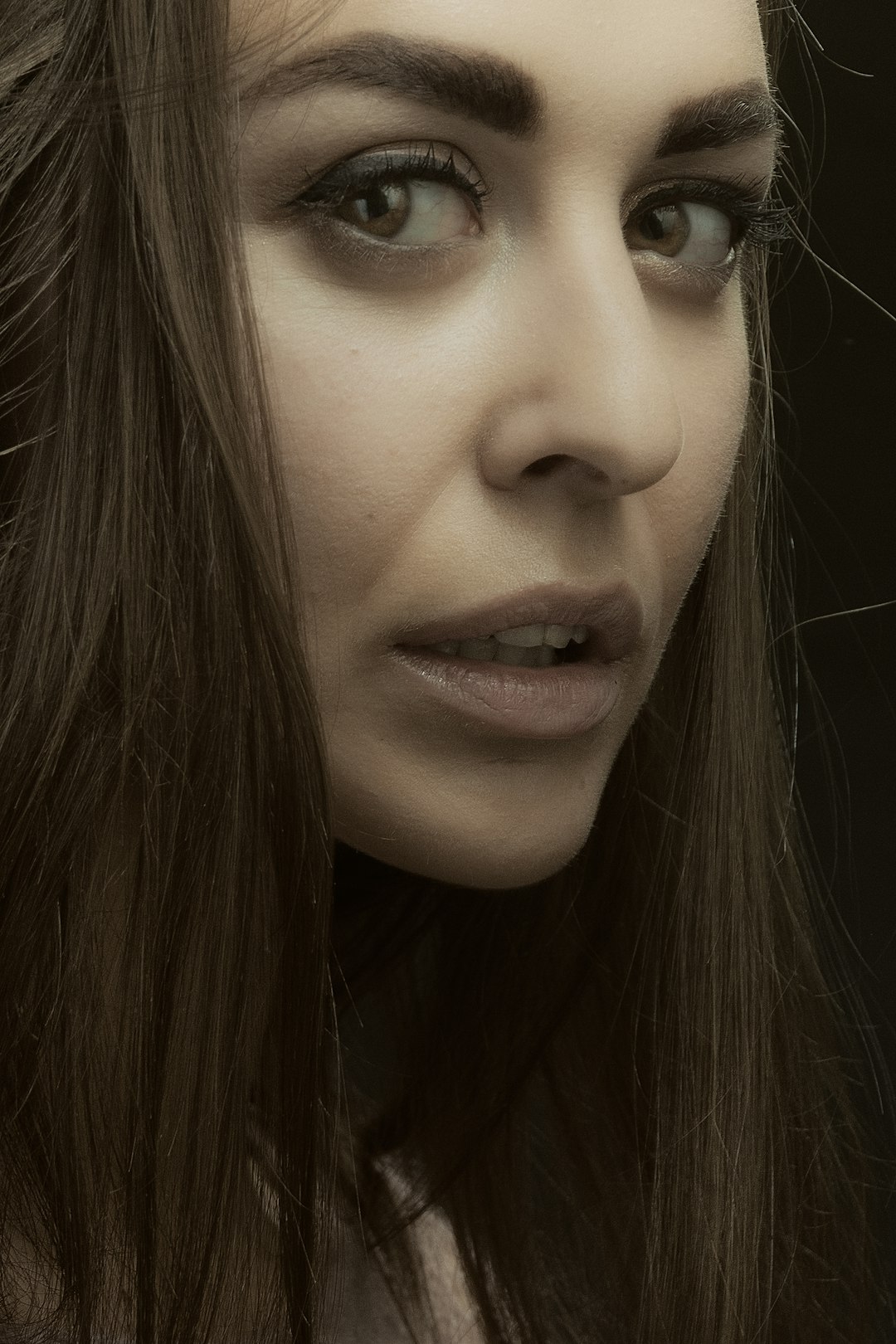 woman with black hair and wearing black shirt