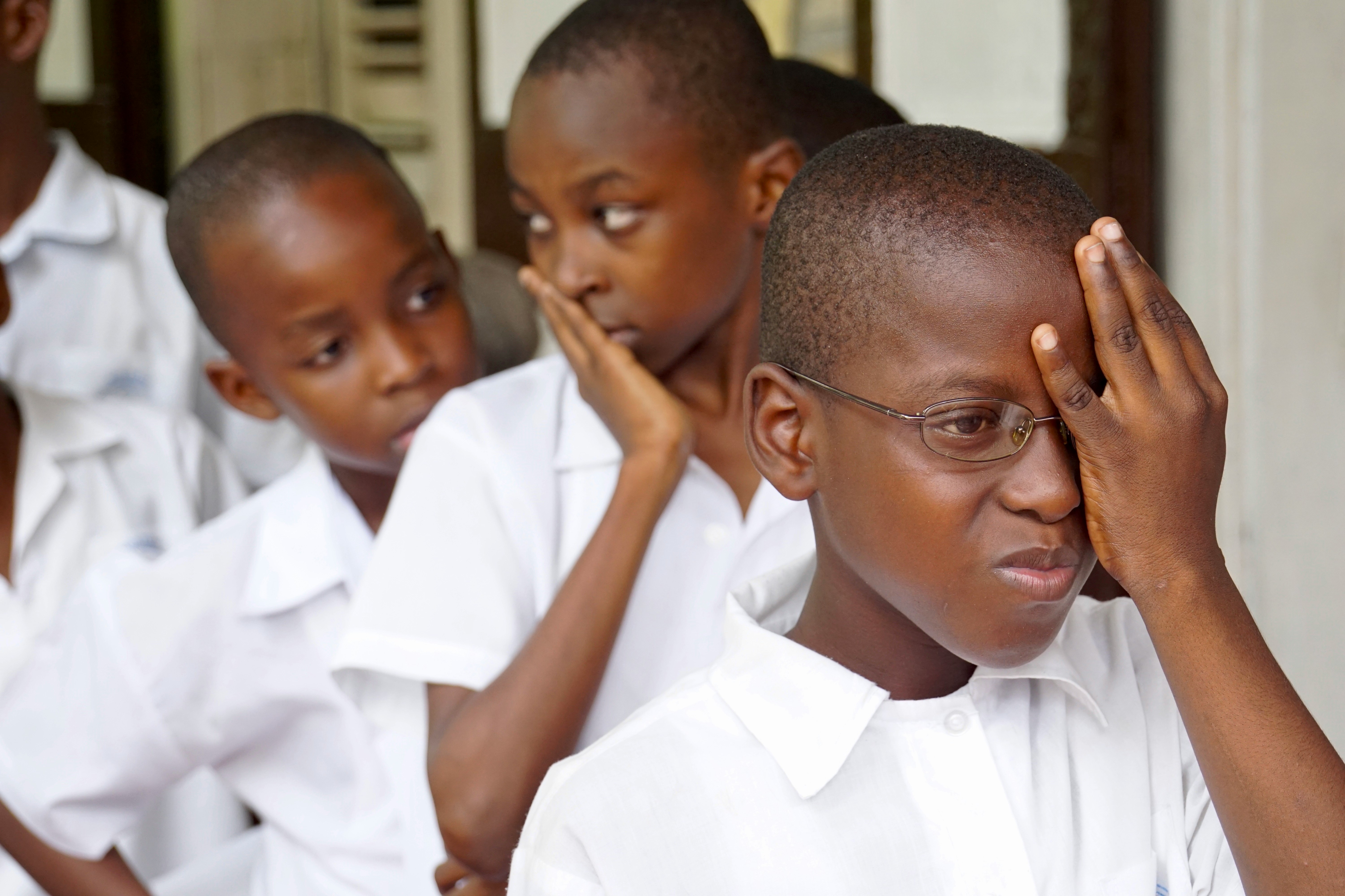 Haitian children lining up for an eye exam. Those that needed it received glasses.