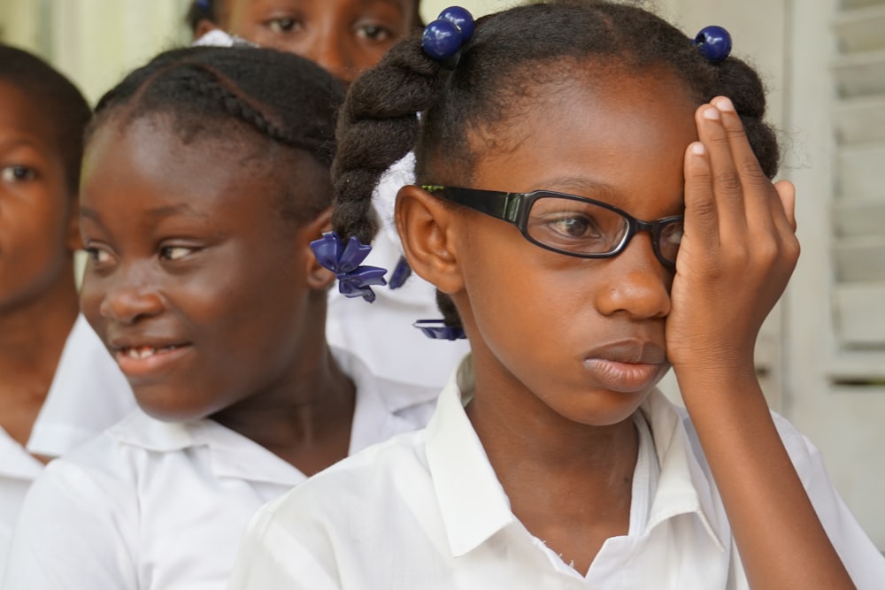 boy in white dress shirt wearing black framed eyeglasses