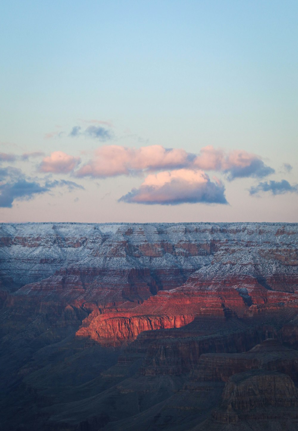 brown rocky mountain under white clouds during daytime