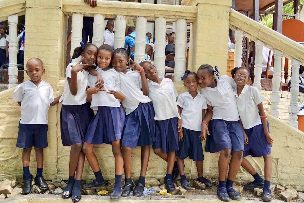 group of people wearing white polo shirt and blue skirt