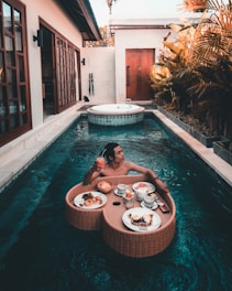 woman in swimming pool during daytime