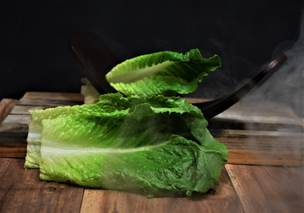 green leaf vegetable on brown wooden table