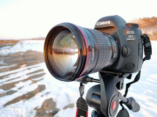 black nikon dslr camera on black tripod