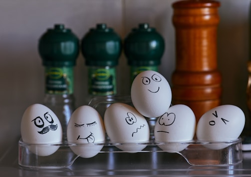 white and black eggs on glass rack