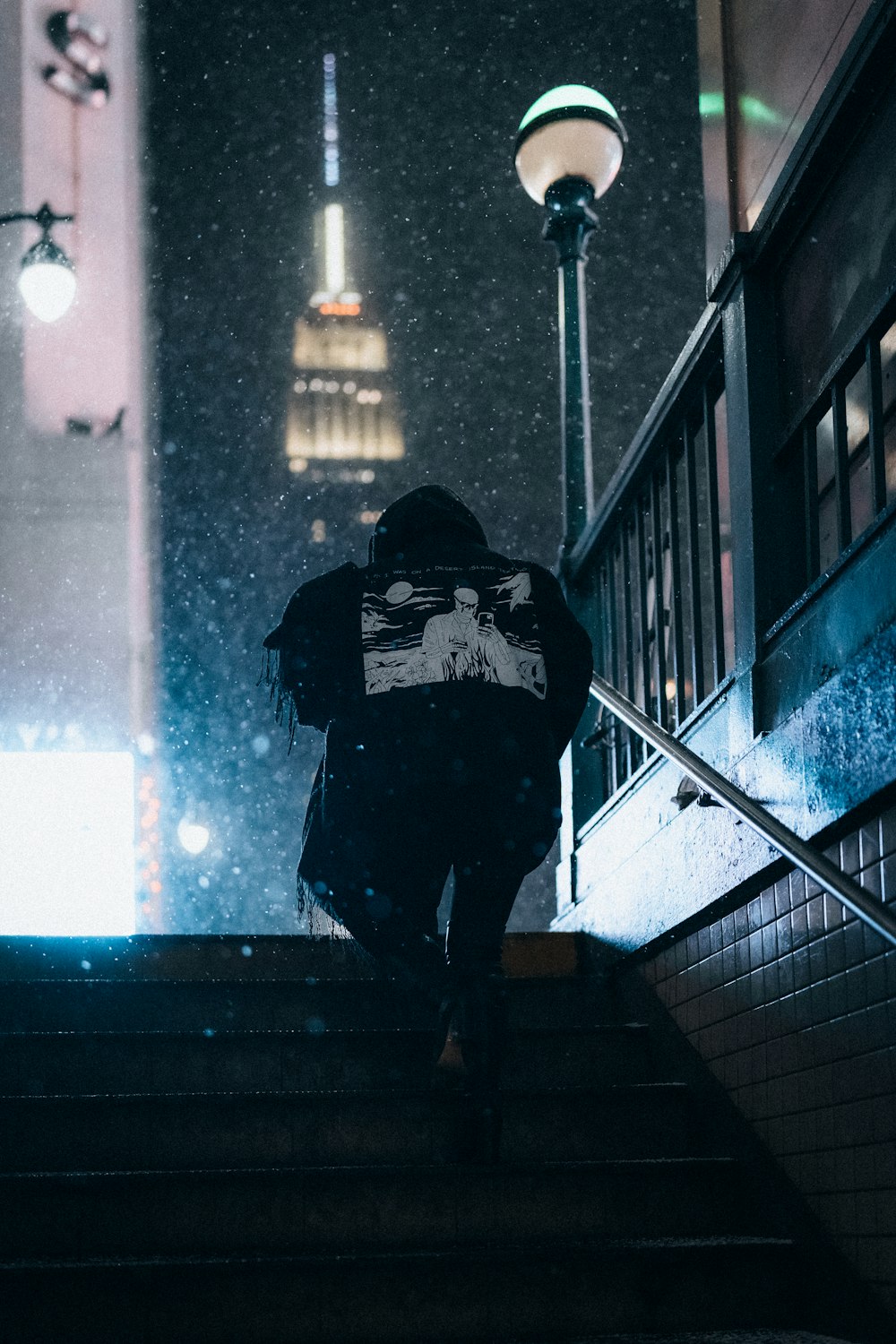 person in black jacket walking on stairs