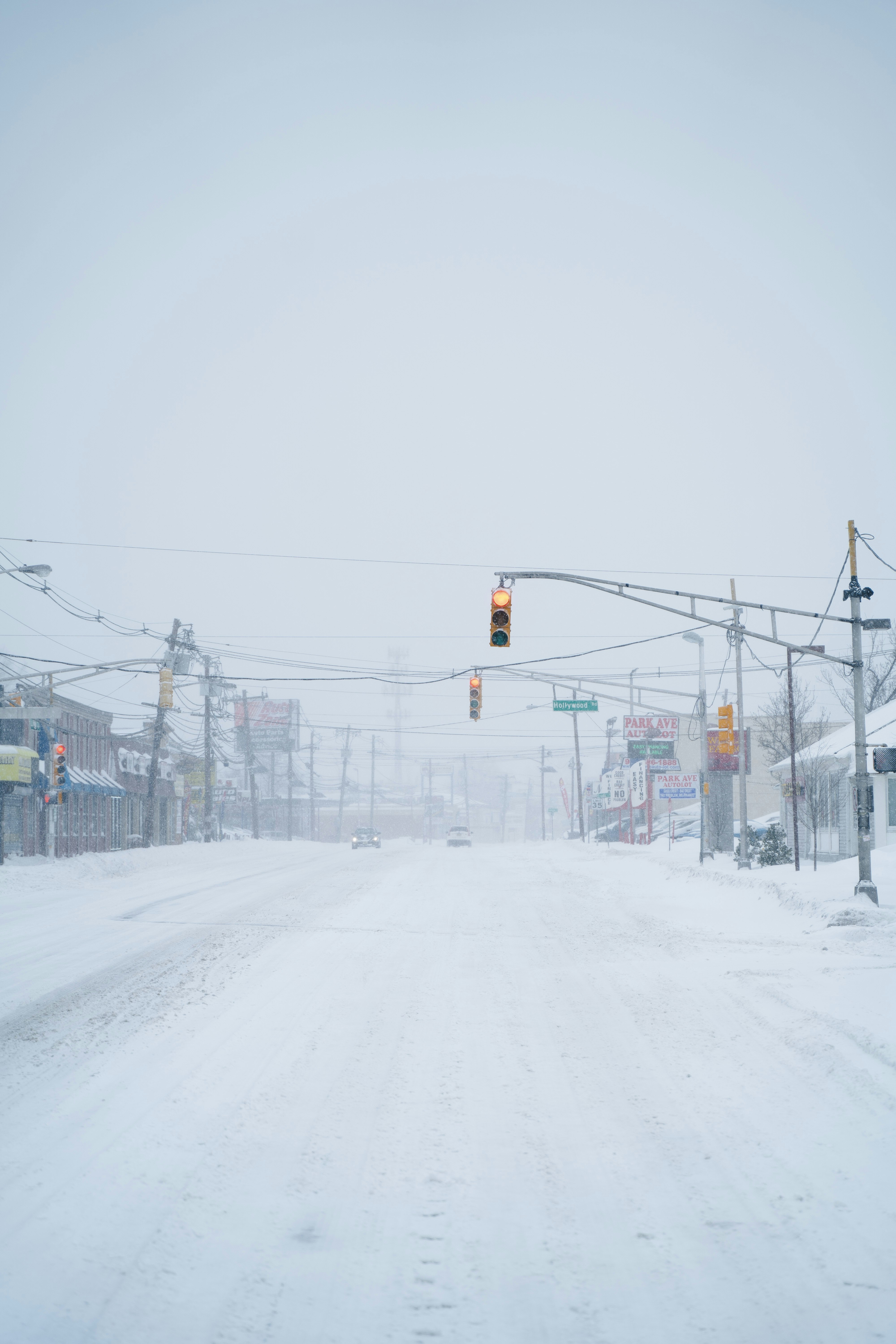 red traffic light on snow covered road