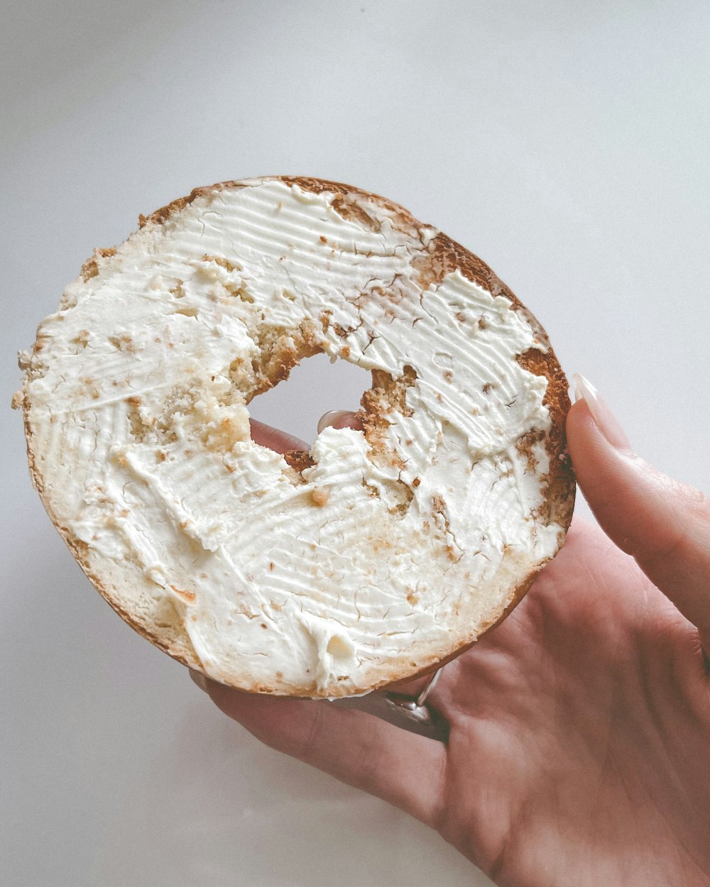 person holding white bread with white cream