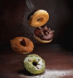 two doughnuts on brown wooden table