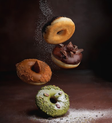 two doughnuts on brown wooden table