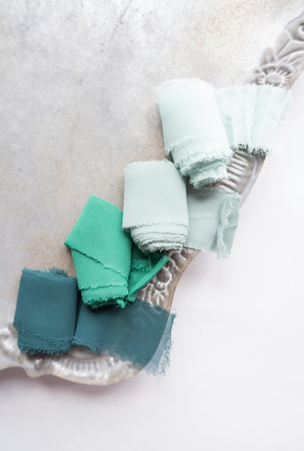 white and green textile on white textile