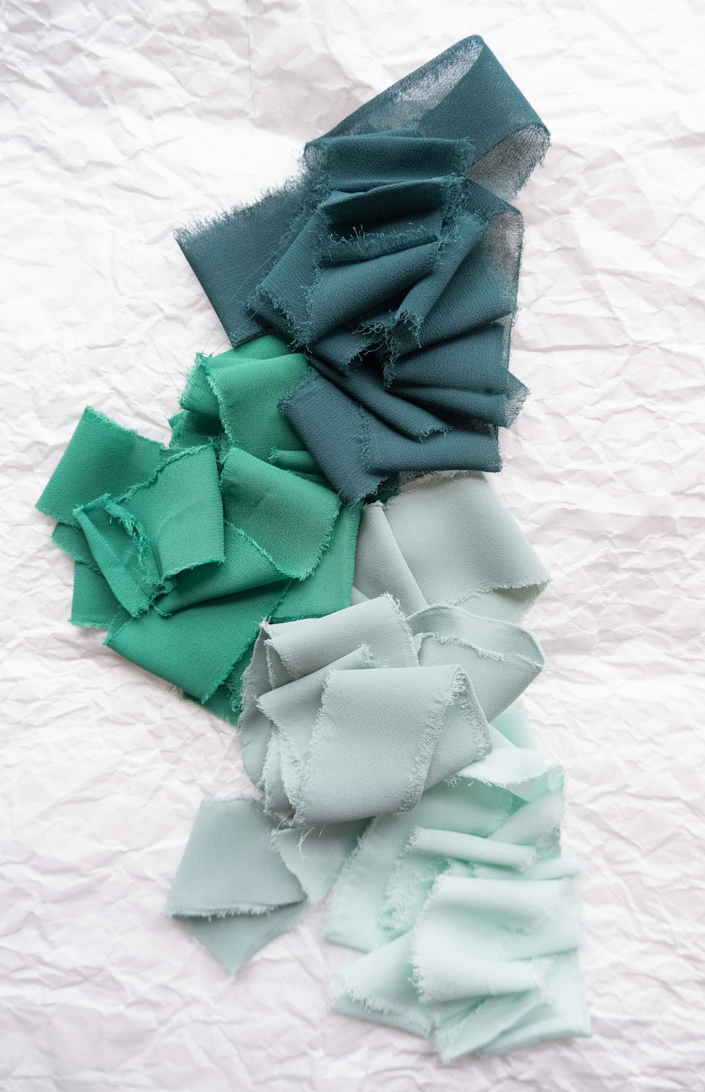 a pile of different colored pieces of cloth