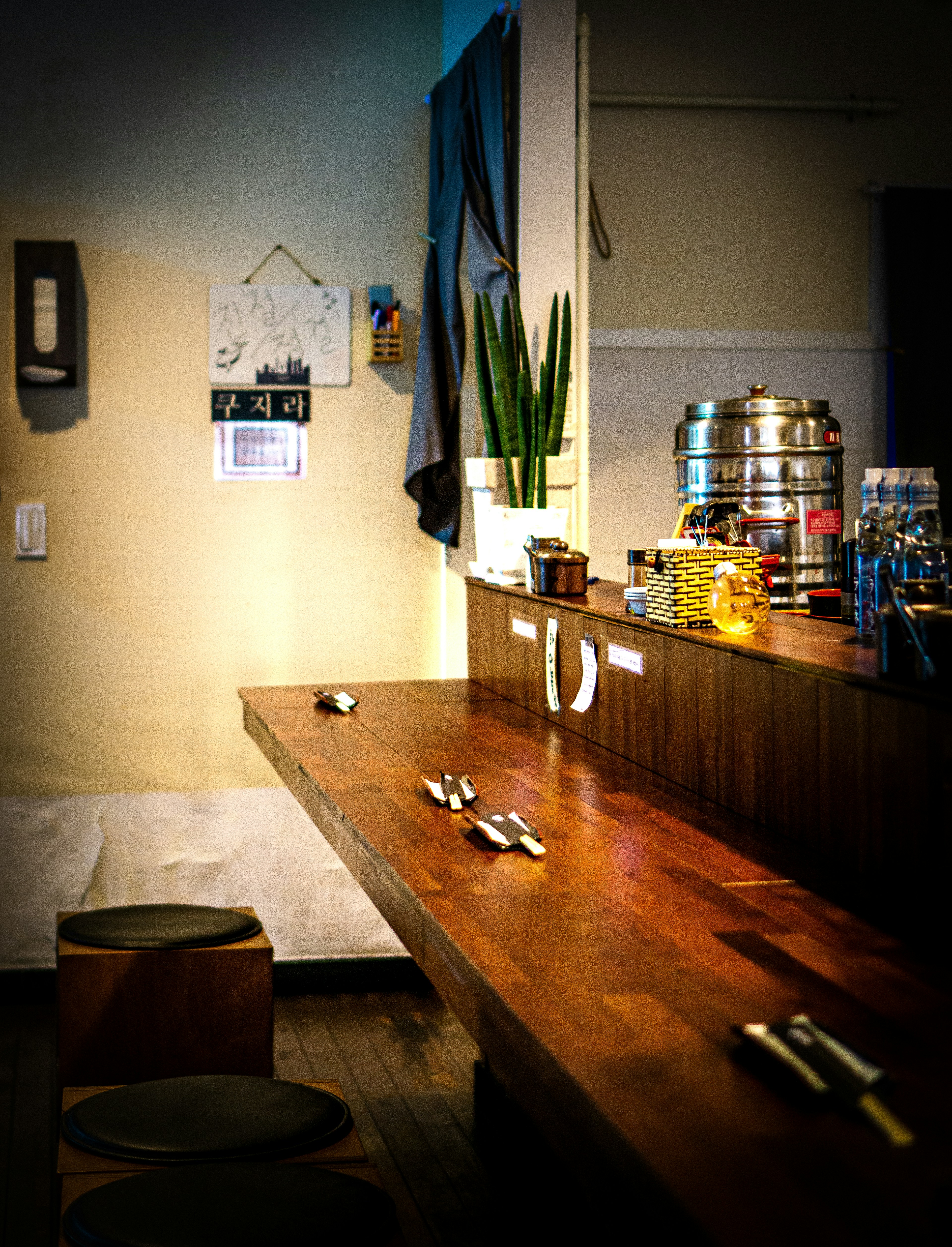 brown wooden table near white wall