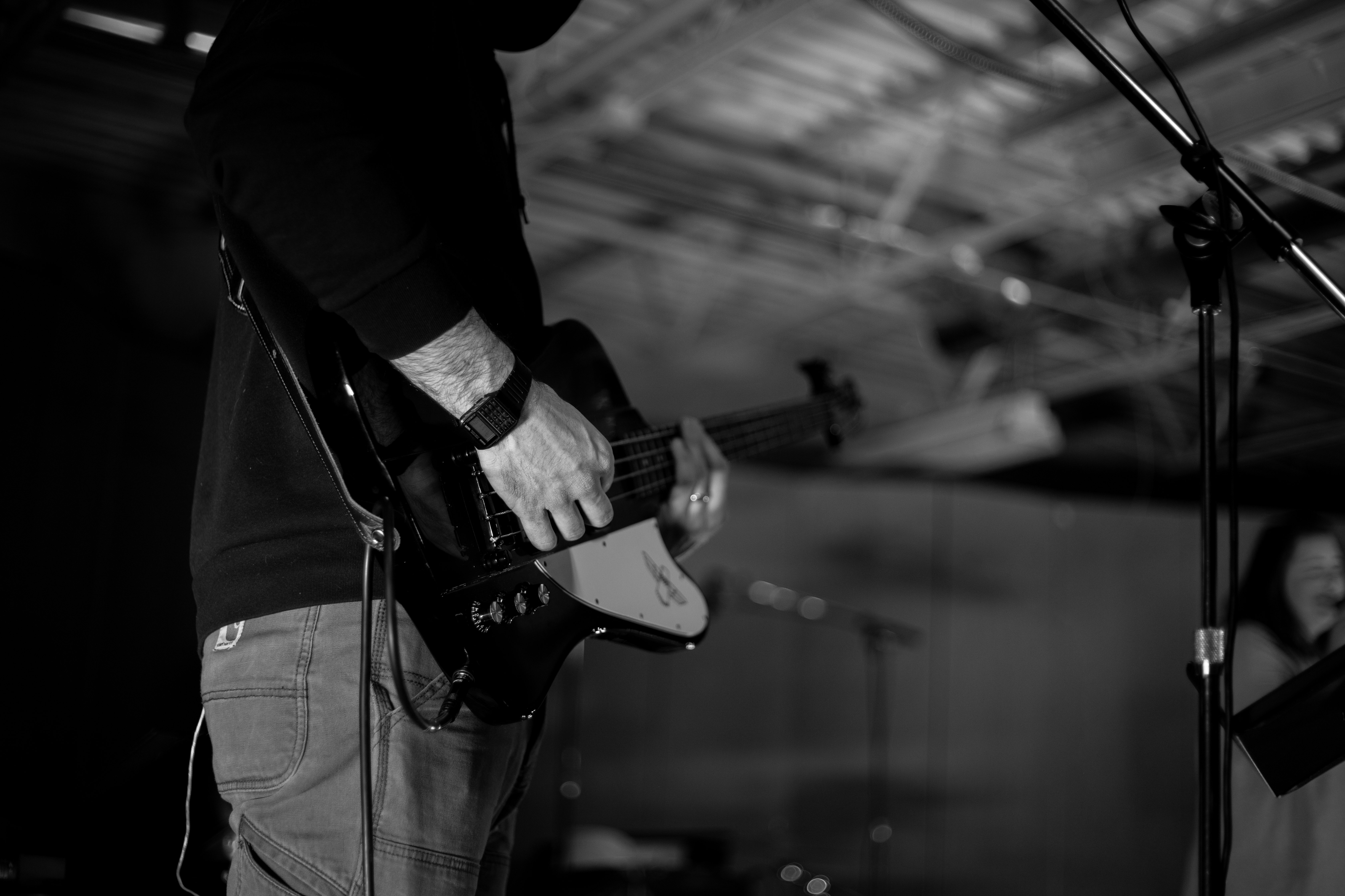 grayscale photo of man playing guitar