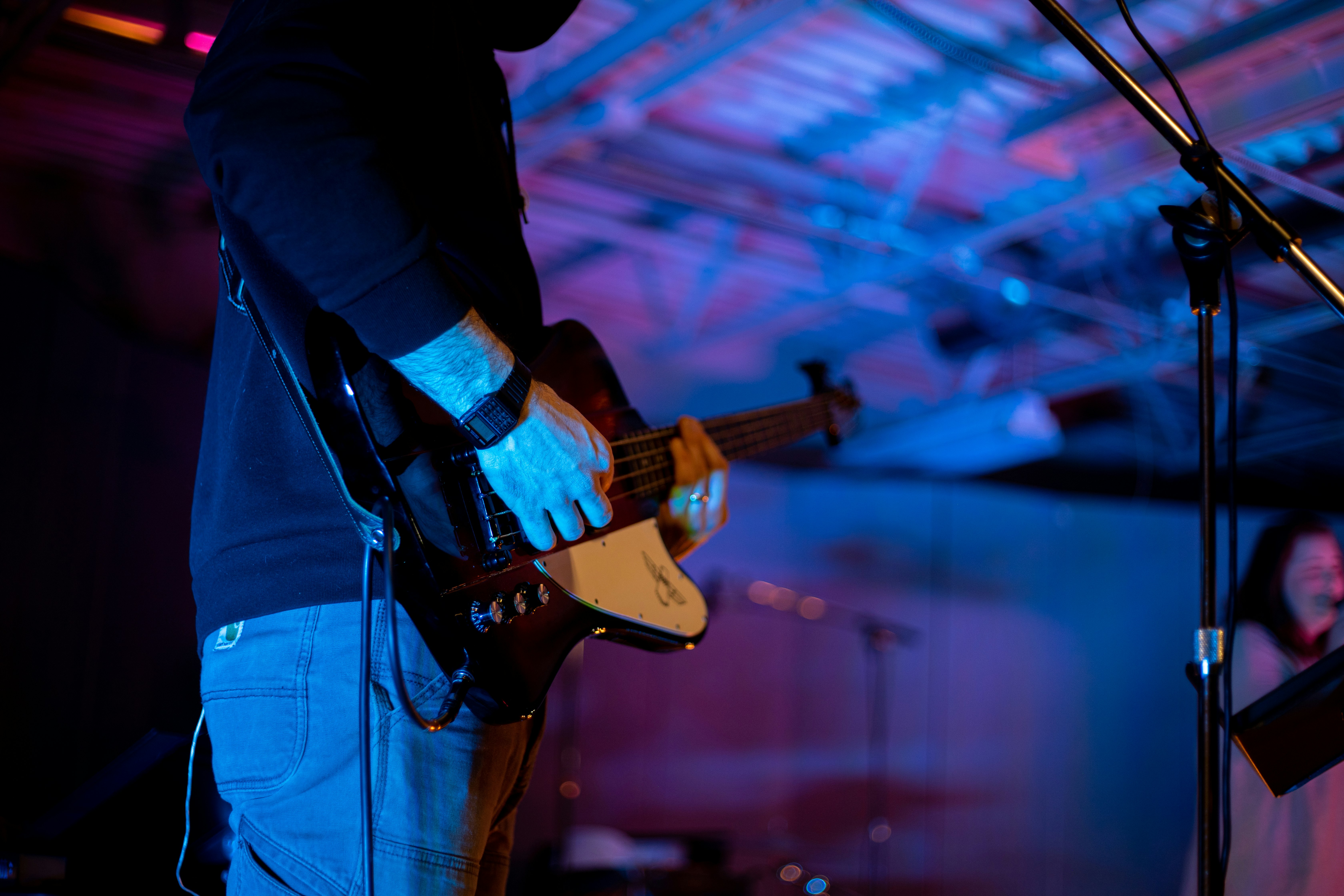 man in black long sleeve shirt playing brown acoustic guitar