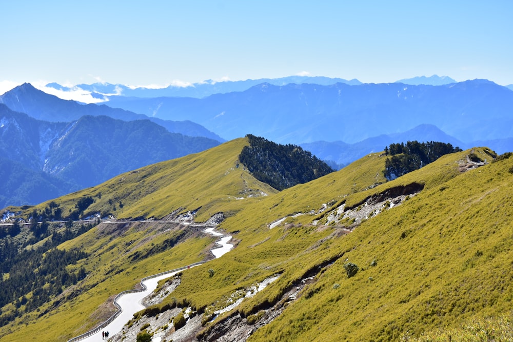 green grass field on mountain during daytime