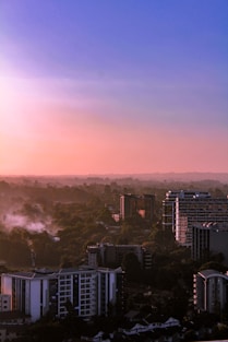city with high rise buildings under orange sky
