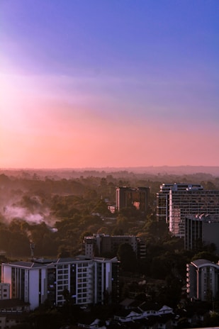 city with high rise buildings under orange sky