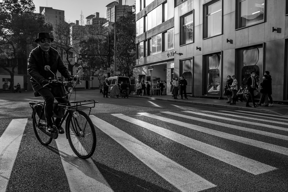 grayscale photo of people walking on pedestrian lane