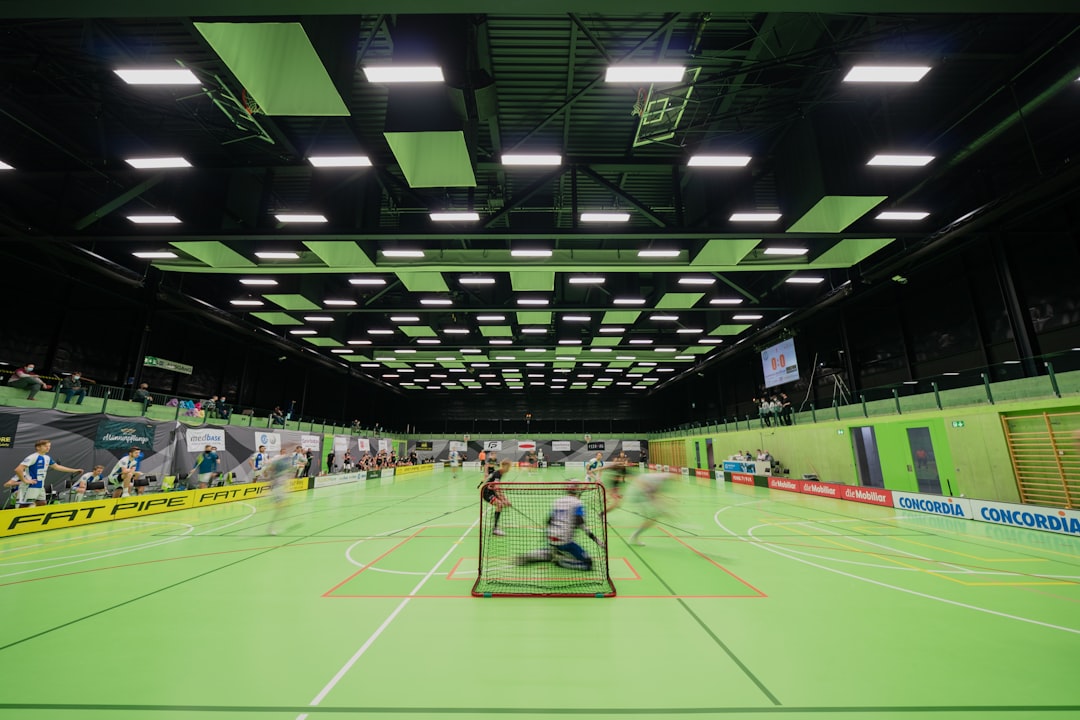 Floorball game in motion in a nearly empty arena during the covid pandemic.