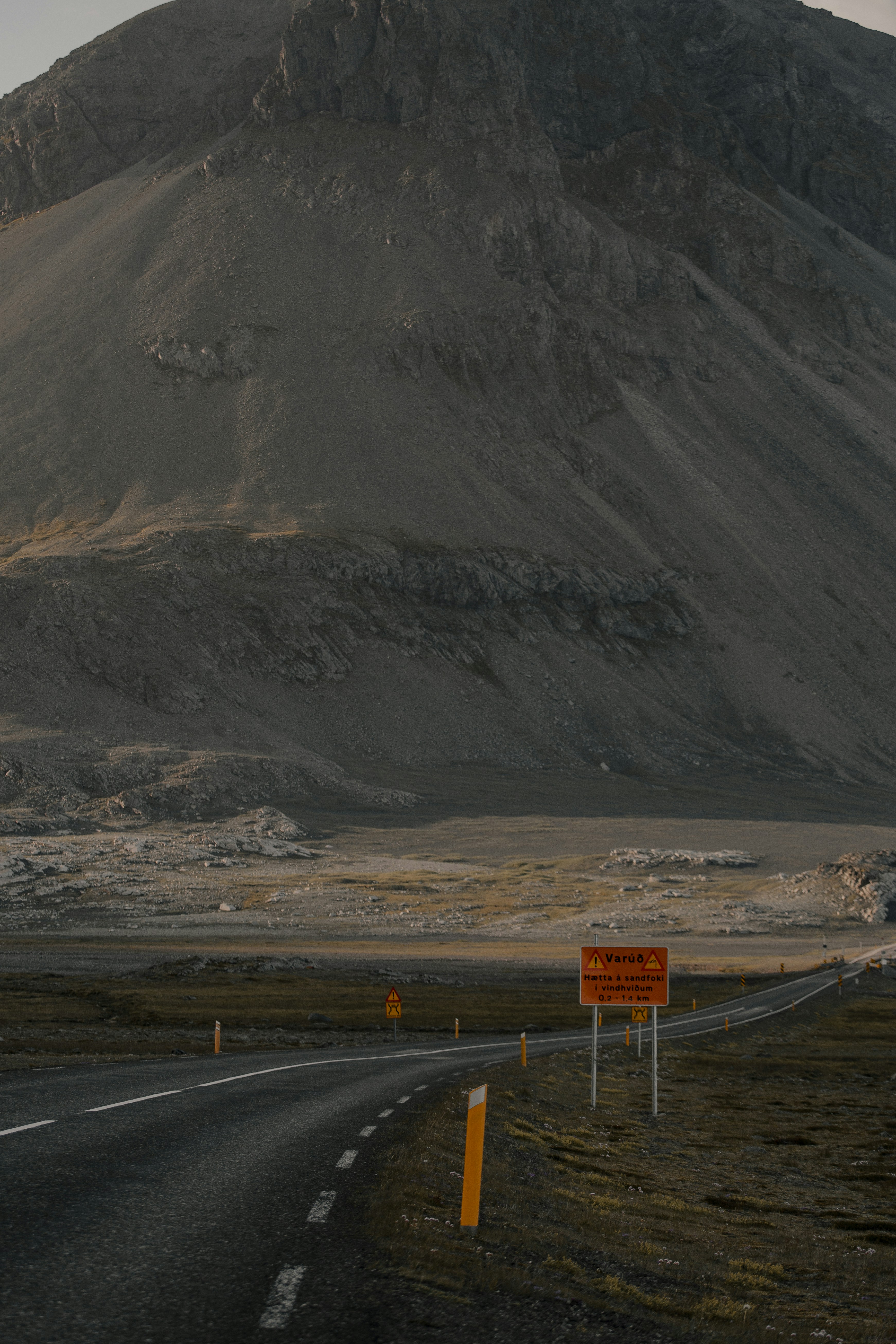 gray asphalt road near gray mountain during daytime