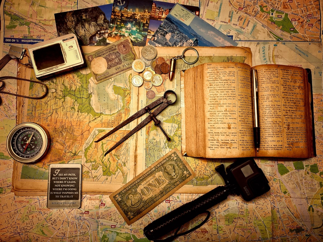 black and silver scissors beside brown book and black and silver scissors,