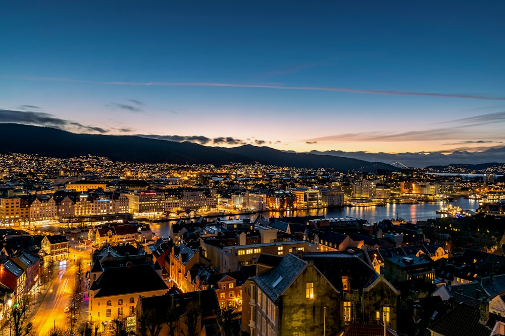 a view of a city at night from a hill